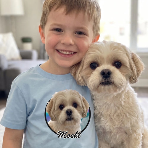 Boy in a light blue kids' custom pet photo circle t-shirt cuddling his Shih Tzu