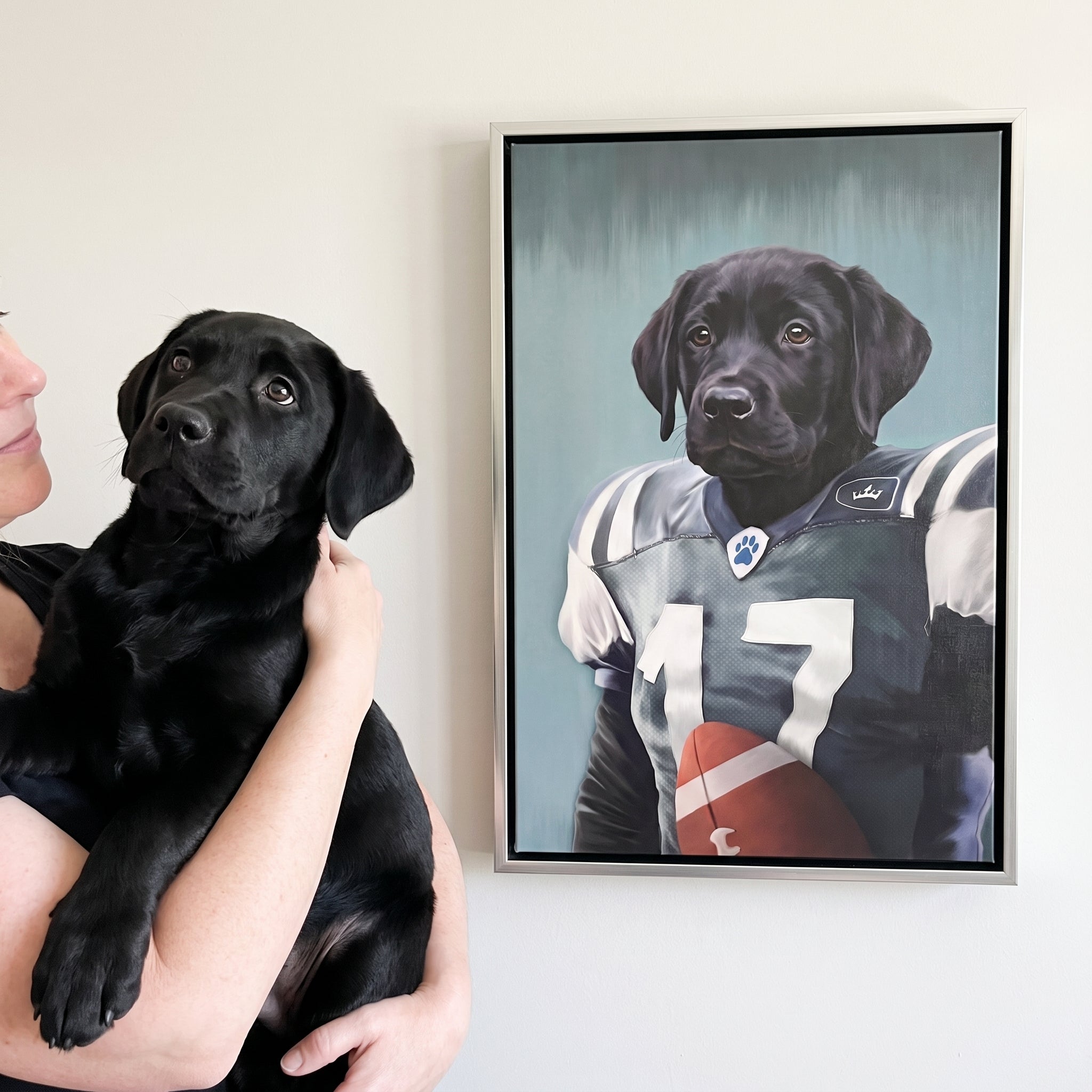 Black labrador next to its The Football Player custom pet canvas